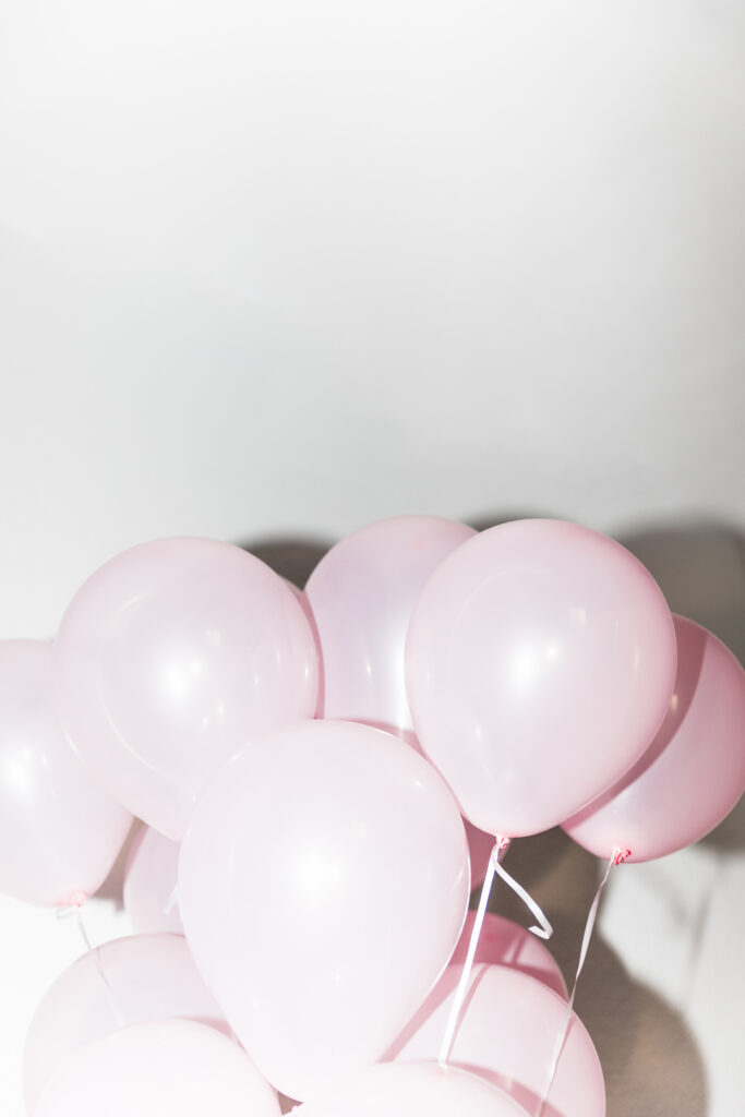 close-up-pink-inflatable-balloon-against-white-backdrop